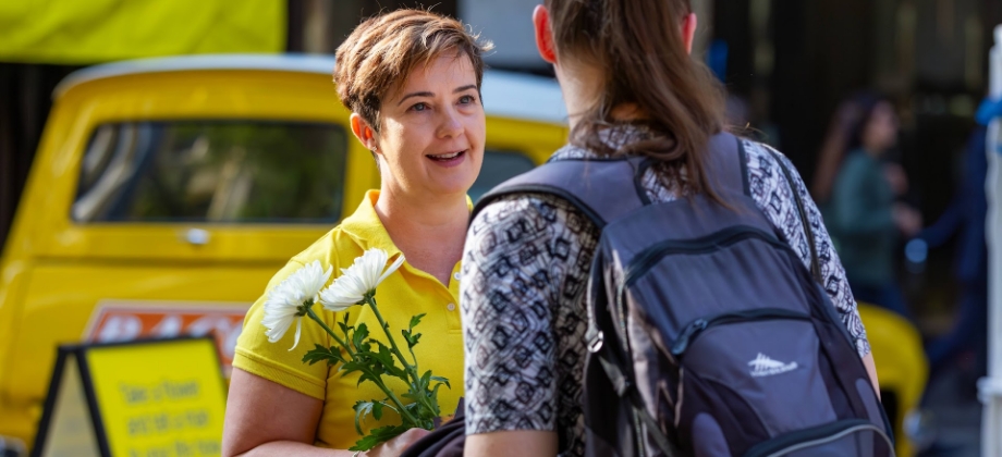 RACQ staff handing out flowers