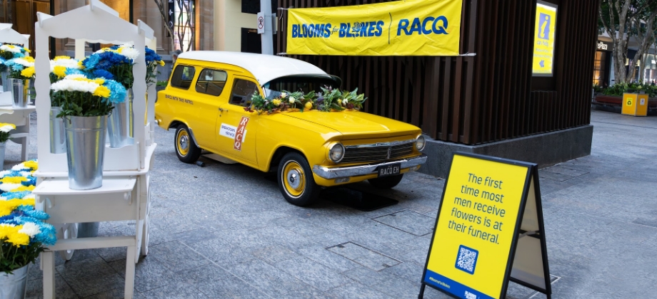 Blooms for blokes activation set up with flowers and old RACQ fleet vehicle