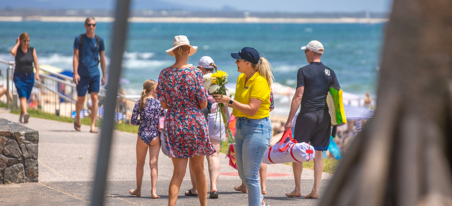 blooms for blokes racq staff and woman on the beach