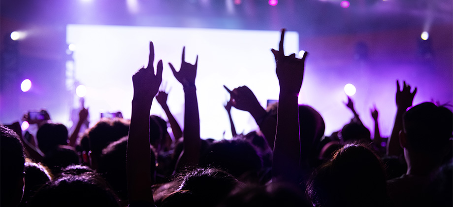People at concert with hands in air