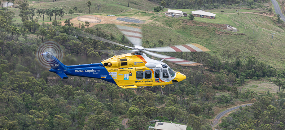 RACQ Chopper helicopter flying over fields