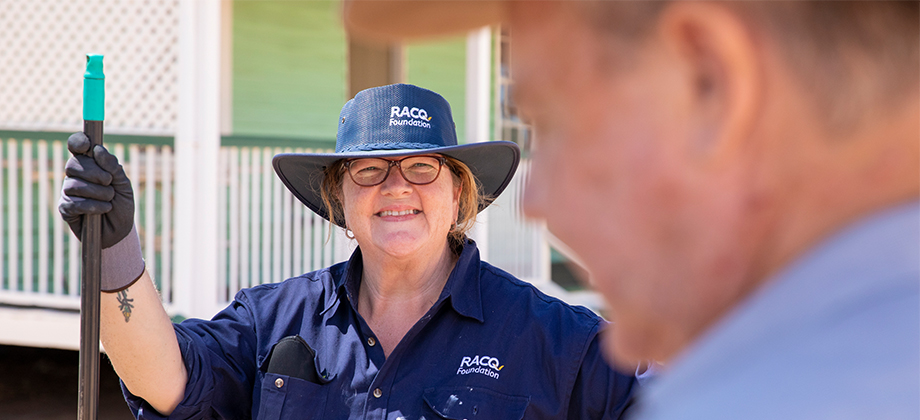 racq woman holding broom