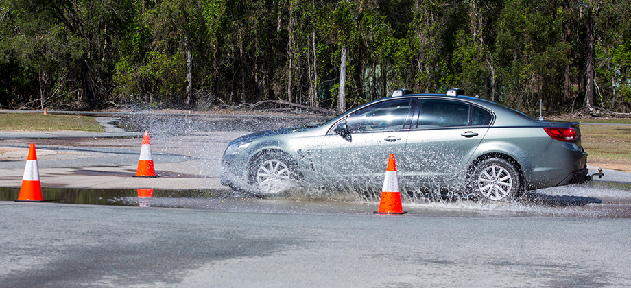 car driving through water side view