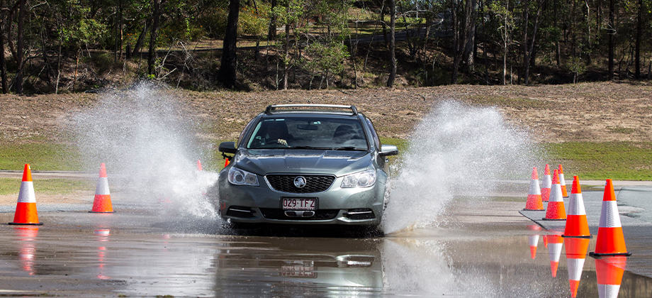 car driving through water safety cones front