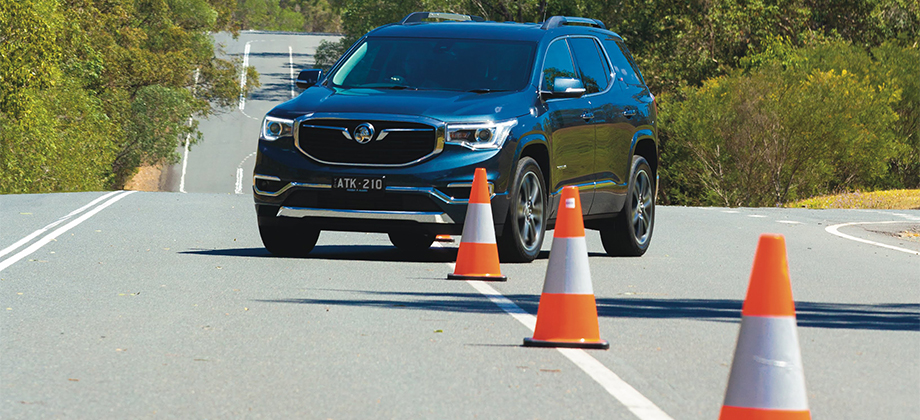 car driving around safety cones