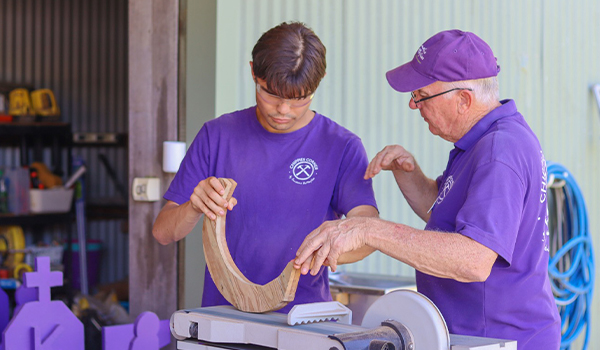 Man teaching young man wood working