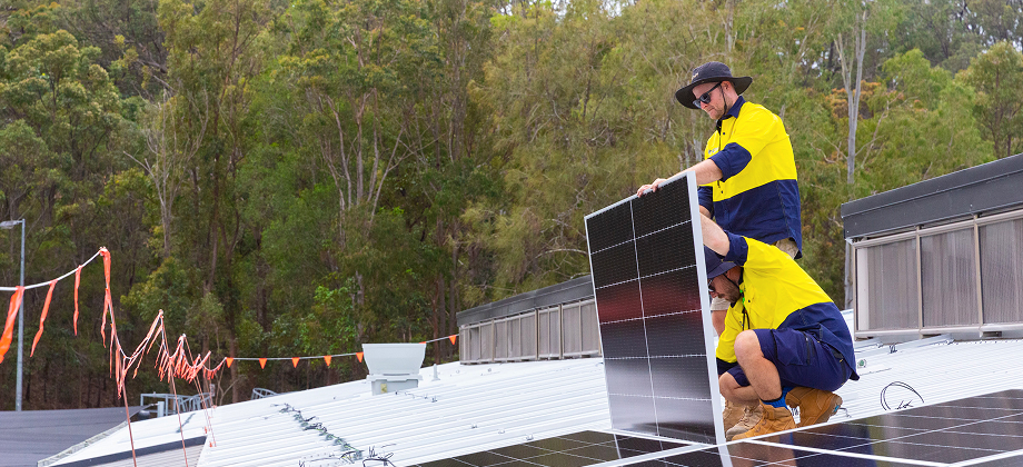 two men installing solar roof panelling