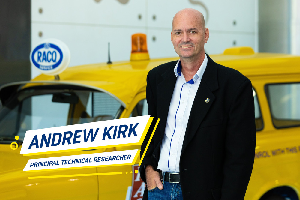 A man standing in front of a yellow car. He is smiling at the camera. The text on the photo says "Andrew Kirk, Principal Technical Researcher."