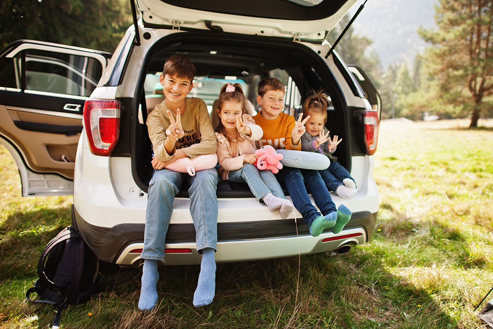 Children sitting in the back of an SUV.
