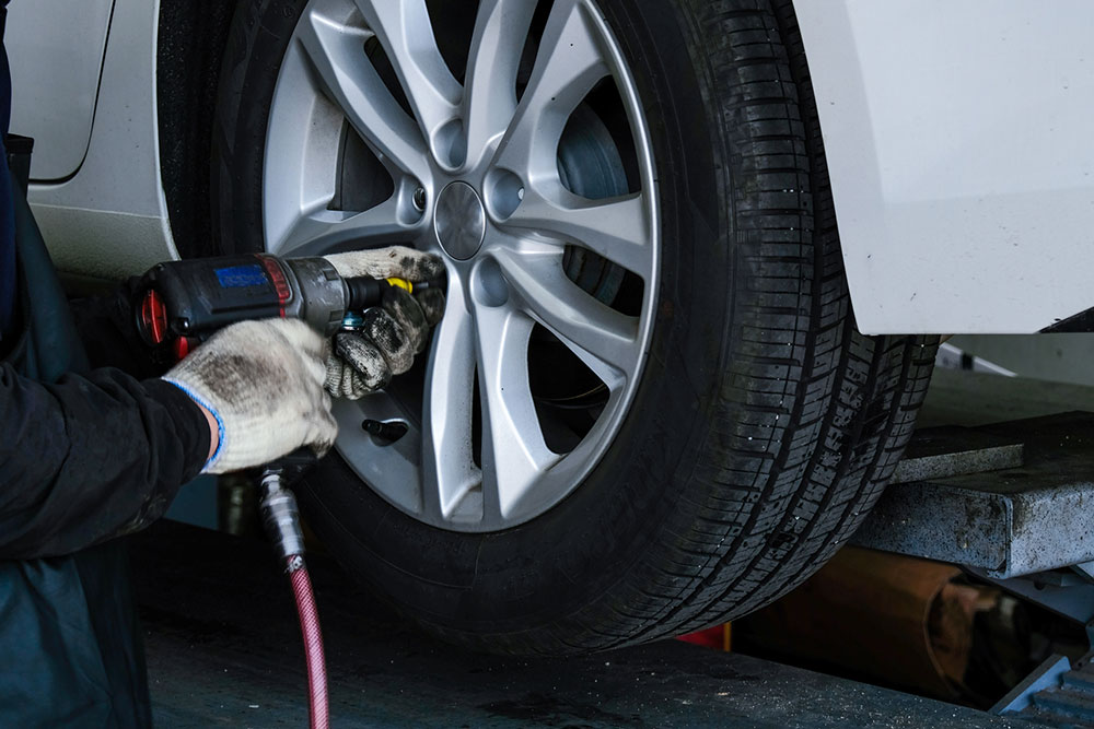 Car tyre being removed.