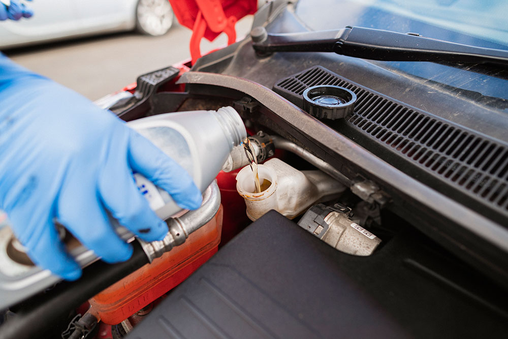 Brake fluid is added to a car.