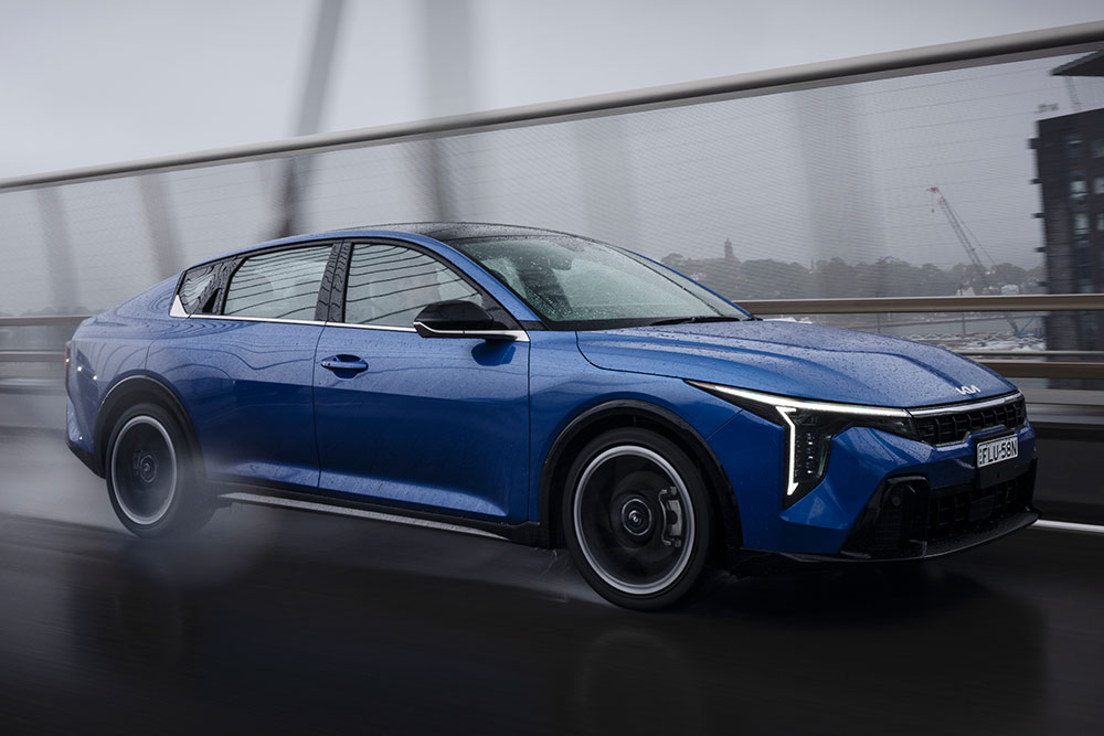 Kia K4 GT-Line sedan on the road.