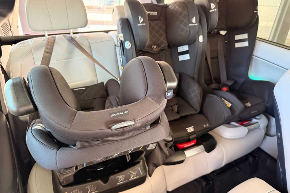 Hyundai Palisade with two forward facing and one rear facing child seats.