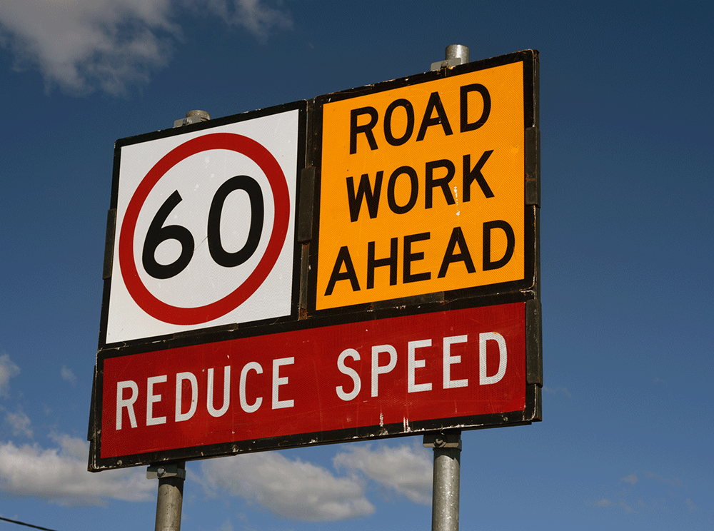 Sign waring of roadworks ahead.