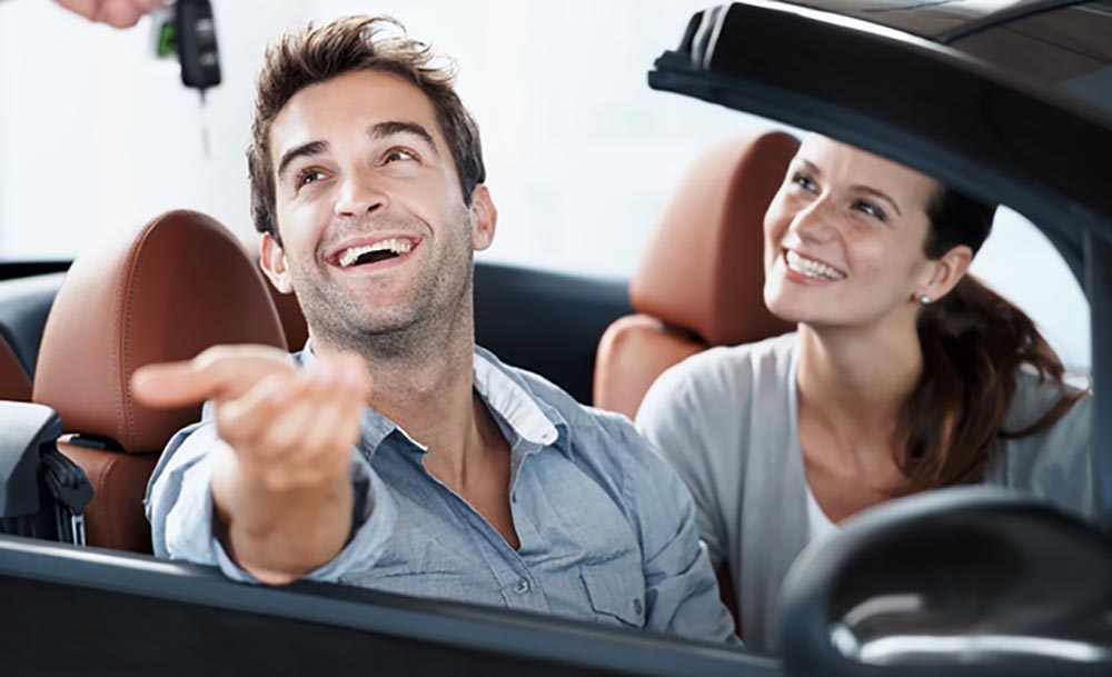 Couple buying a convertible