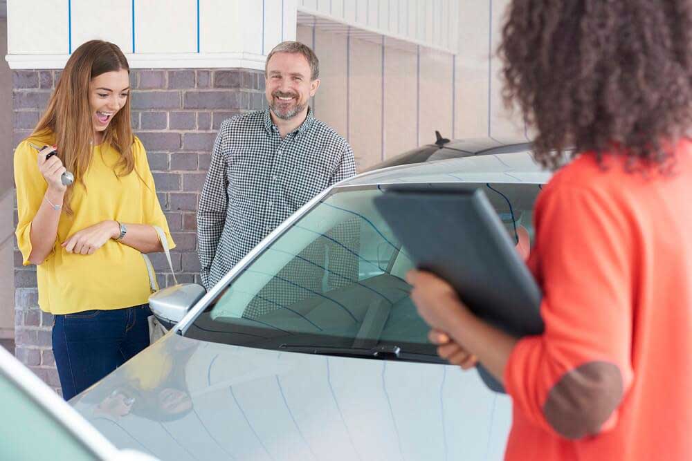man and woman buying a car