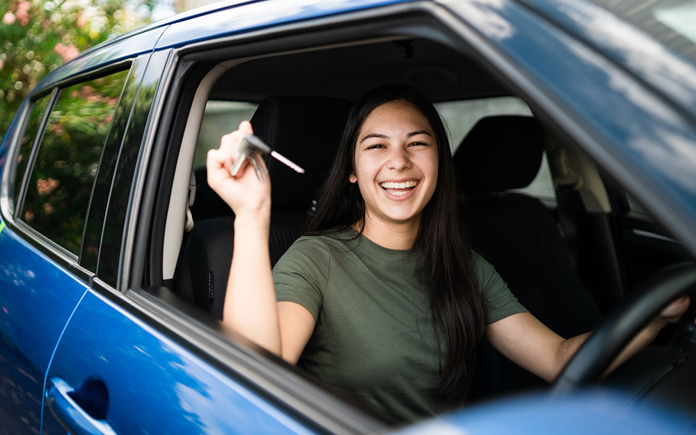 Young girl with keys to her first car.