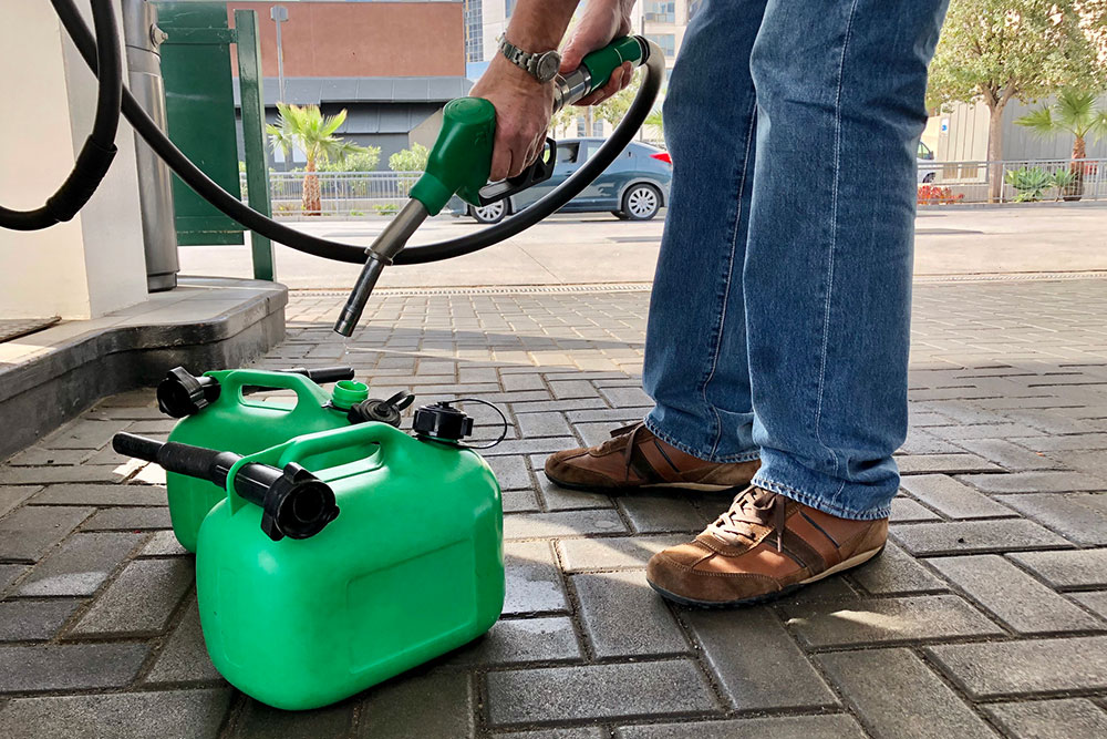Man filling fuel container.