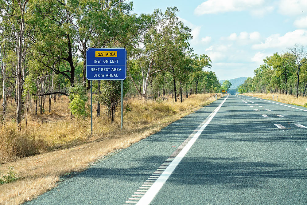 Rest area ahead sign on highway.