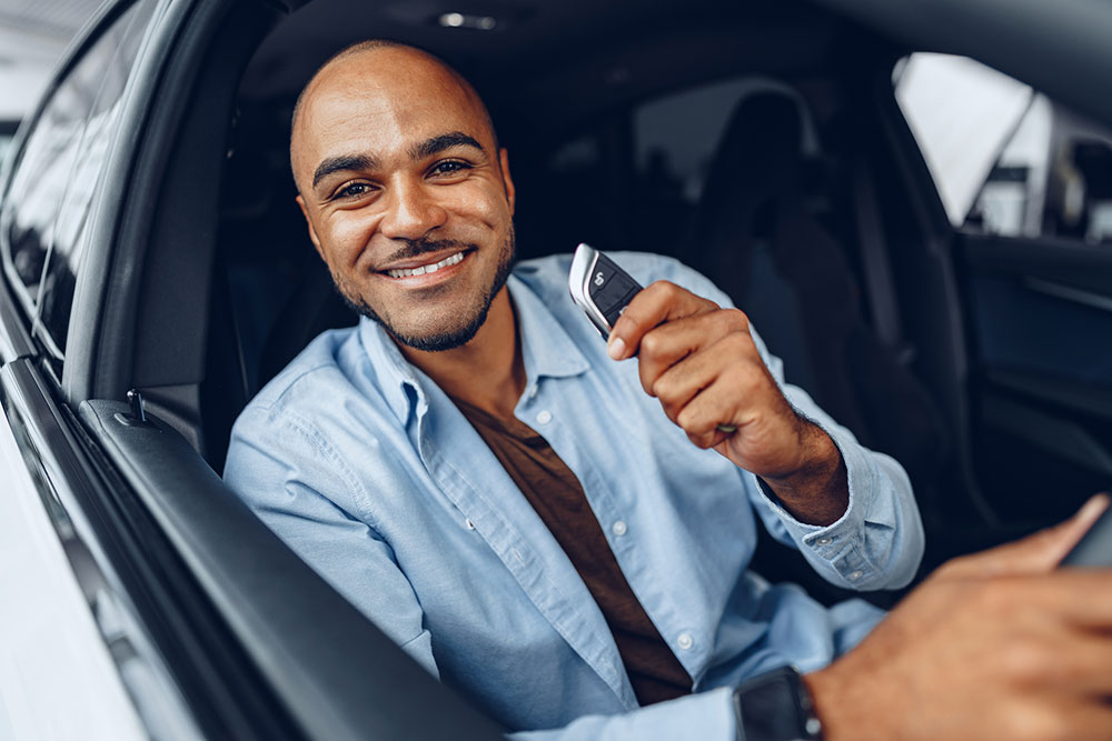 Man behind the wheel of his new car.