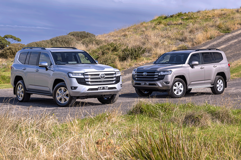 Two Toyota LandCruiser 300 Series models.