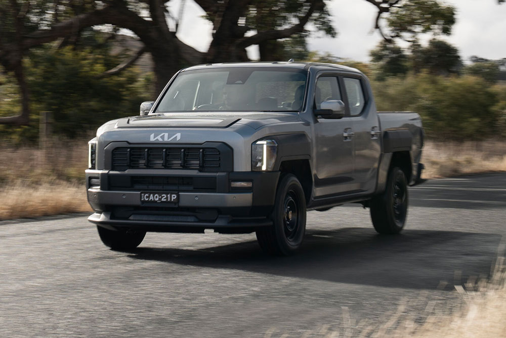 Kia Tasman ute on the road.