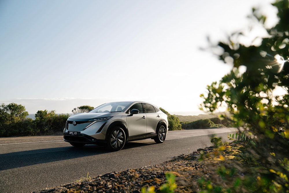 Nissan Ariya side view on the road.