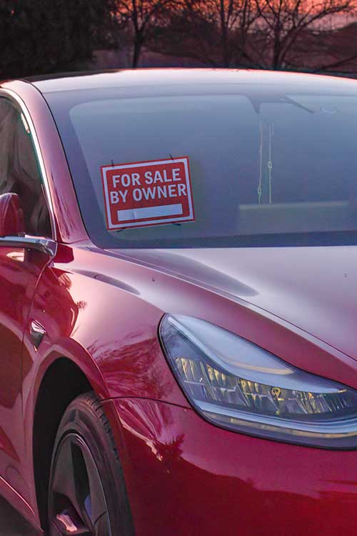 used car with for sale sign in wlindscreen