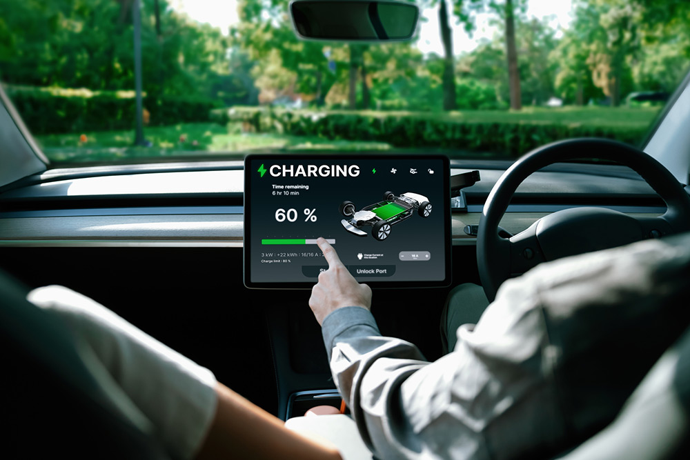 Couple in car check EV charging status.