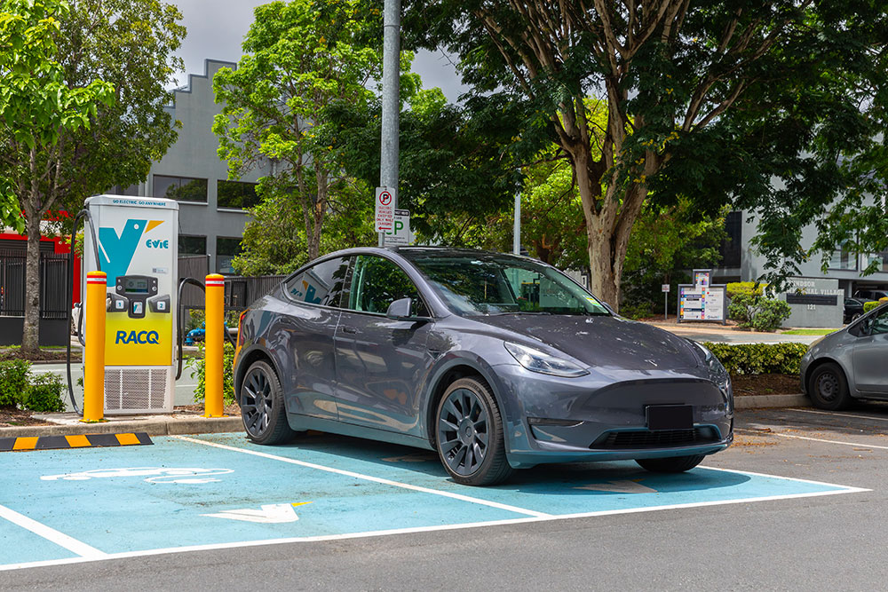 Tesla charging at Evie charging station.