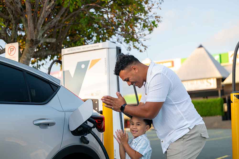 Man and child at Evie charging station.