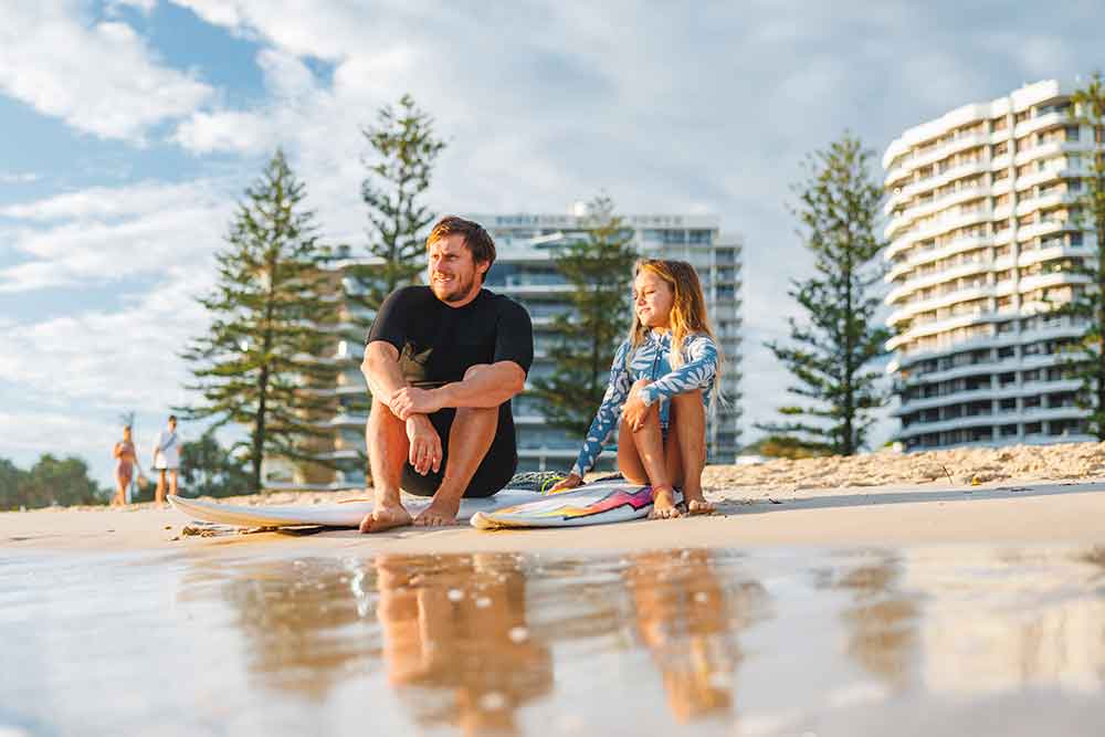 Couple relaxing on a Gold Coast beach.