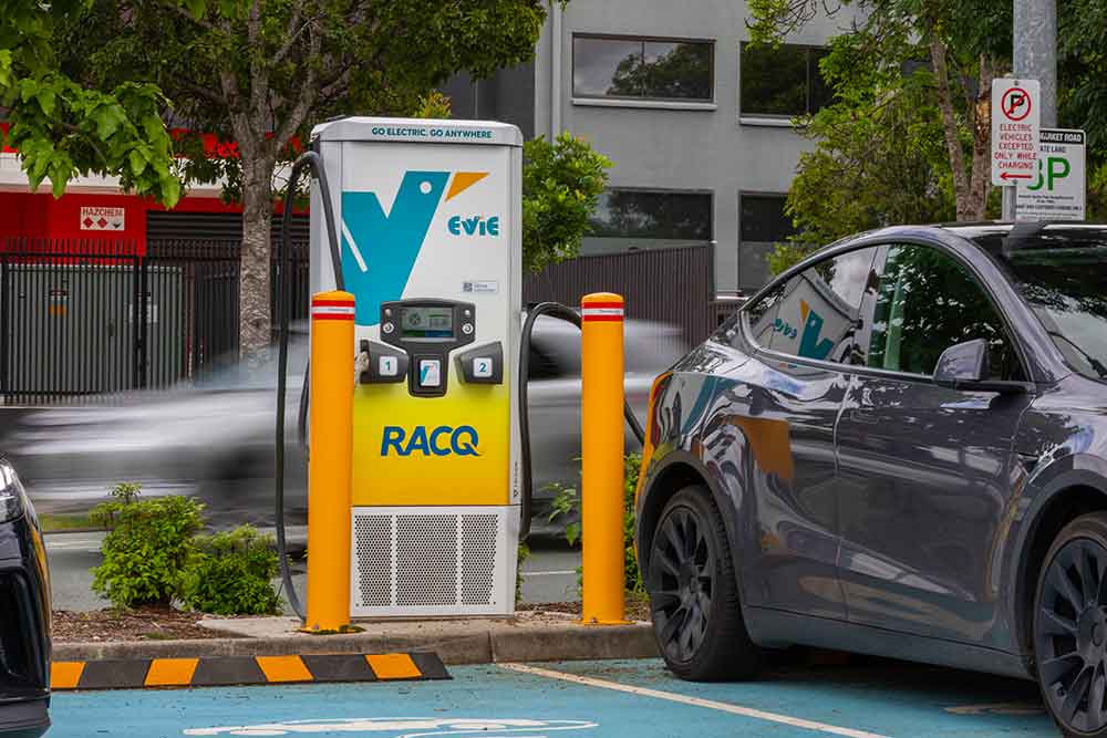 Vehicle recharging at Evie charging station.