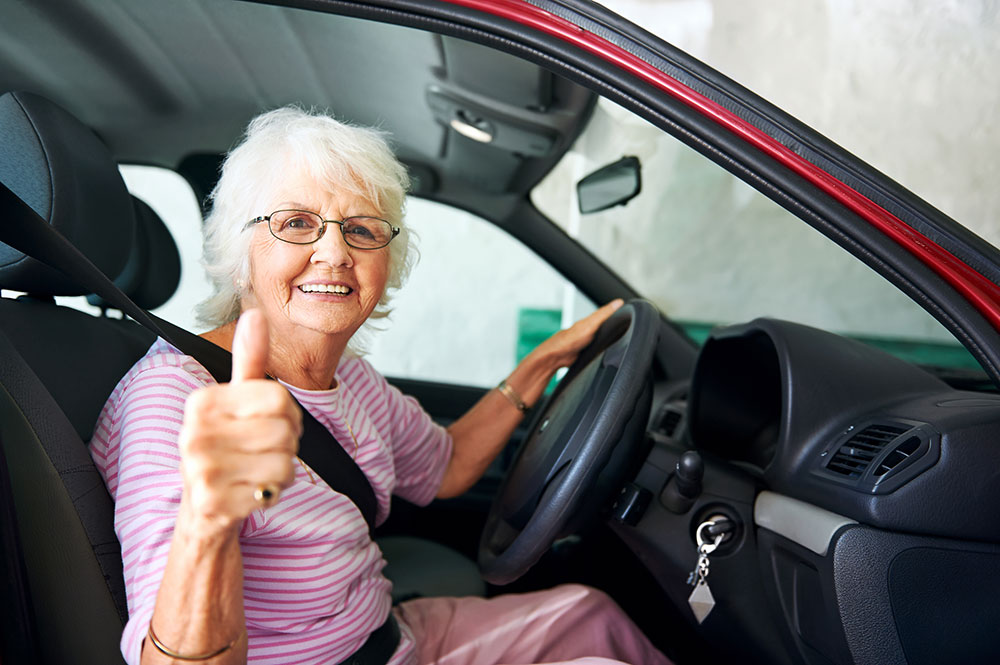 Eldery driver gives the thumbs up