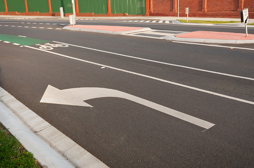 Turn left marking on road.