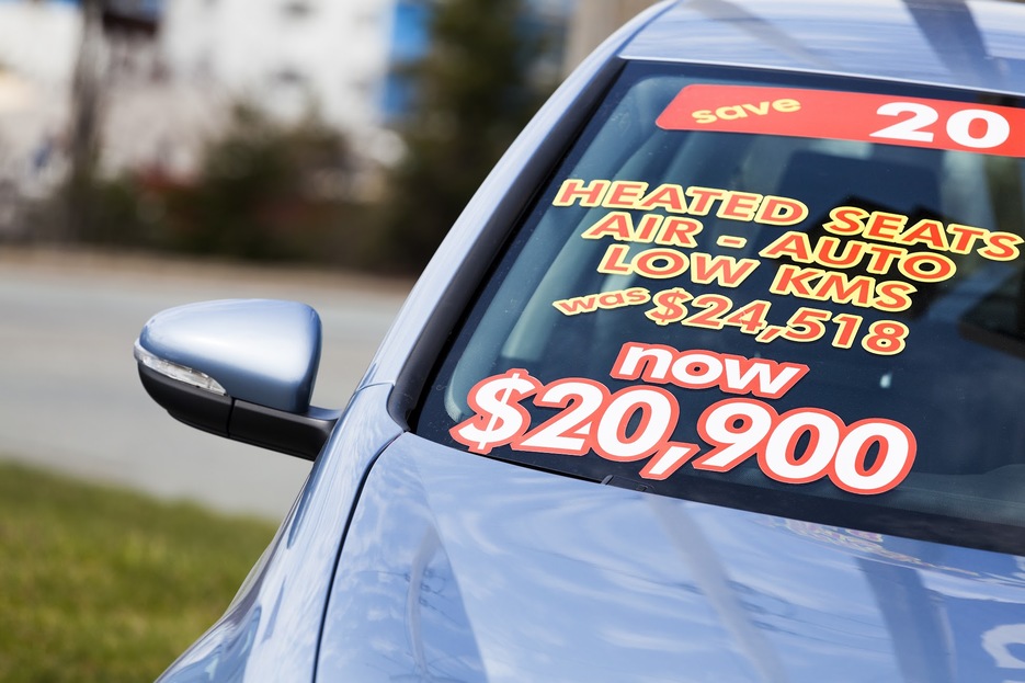 Used car with sales banners