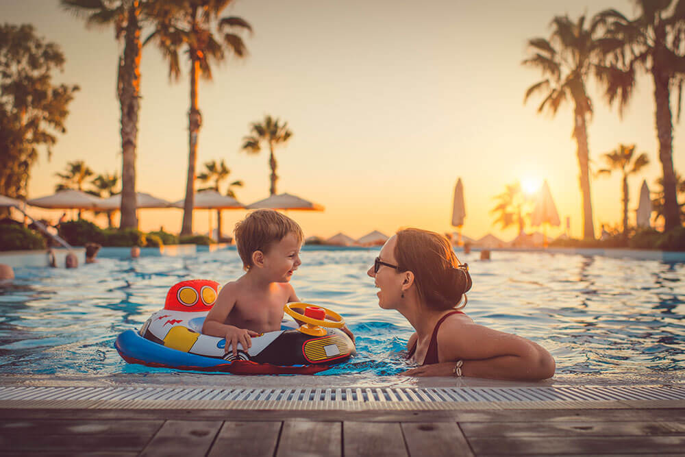 Mother-toddler-son-in-pool-at-resort