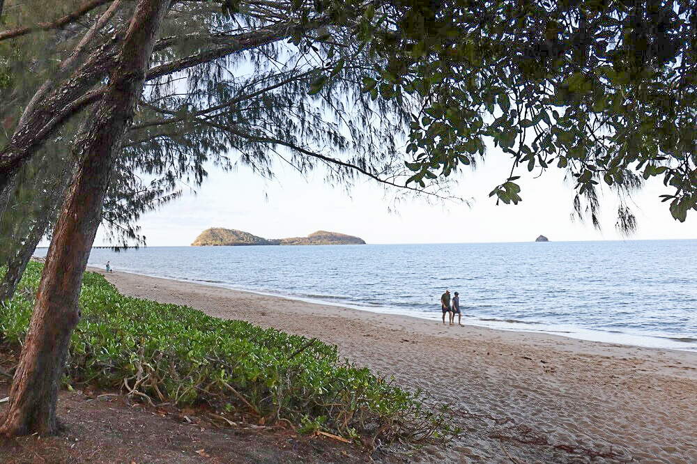 Couple walking along the beach at Palm Cove.