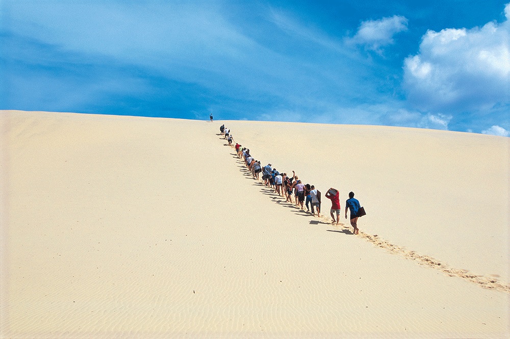 Sand tobogganing on Moreton Island