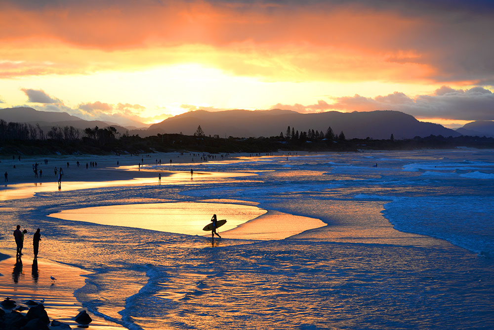 Sun sets over Byron Bay beach.
