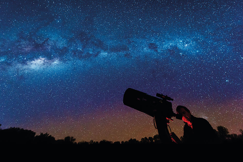 Man looking through telescope at the Cosmos Centre in Charleville.
