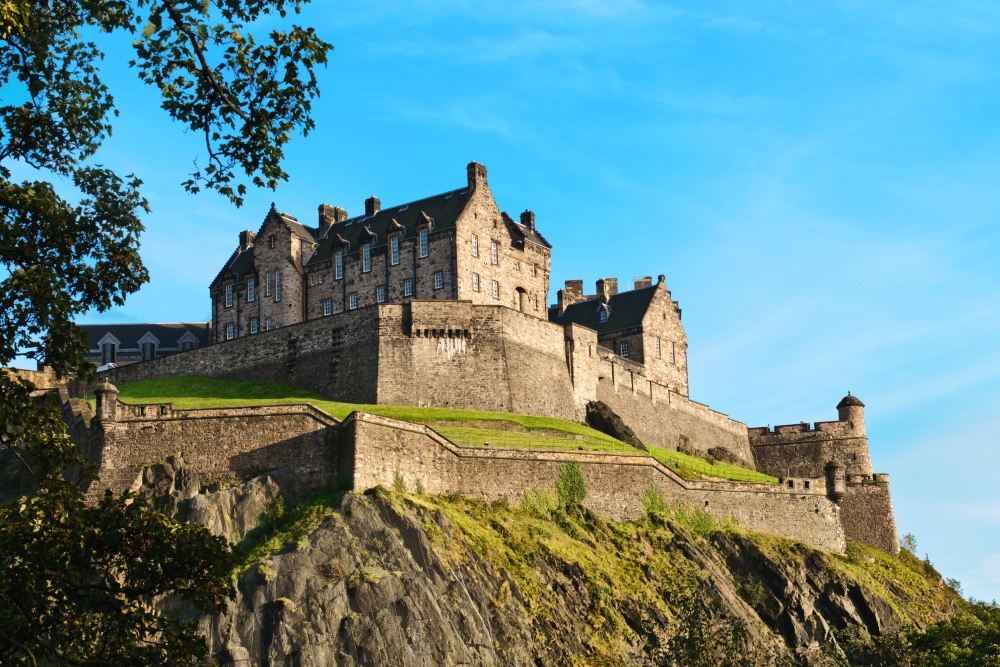 A scenic view of Edinburgh Castle with a clear blue sky