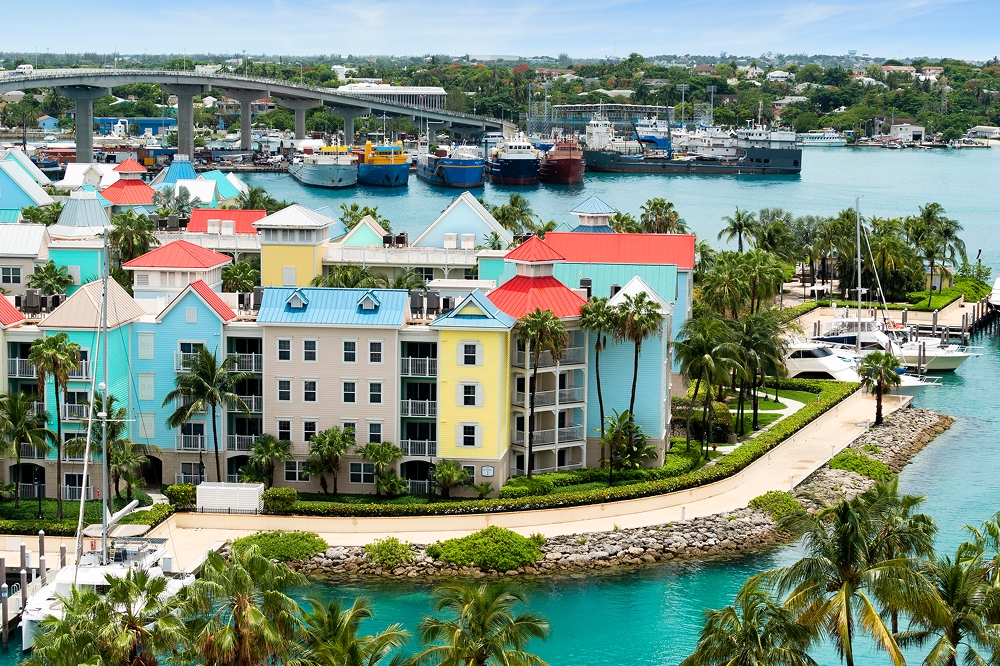 An aerial view of Paradise Island harbor and Nassau with vibrant coloured condos and yachts