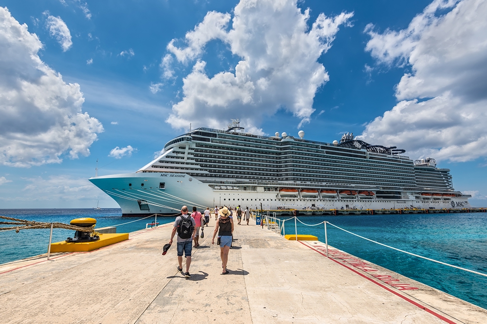 Passengers arriving to a cruise ship to check in and board