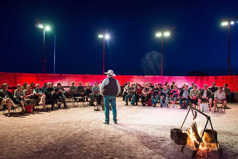 Telling stories of the Outback around a campfire,