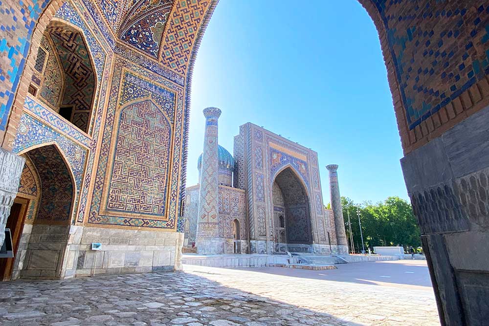 View of Registan Square and Sherdor Madrasah from Tillya Kori Madrasah in Samarkand, Uzbekistan.