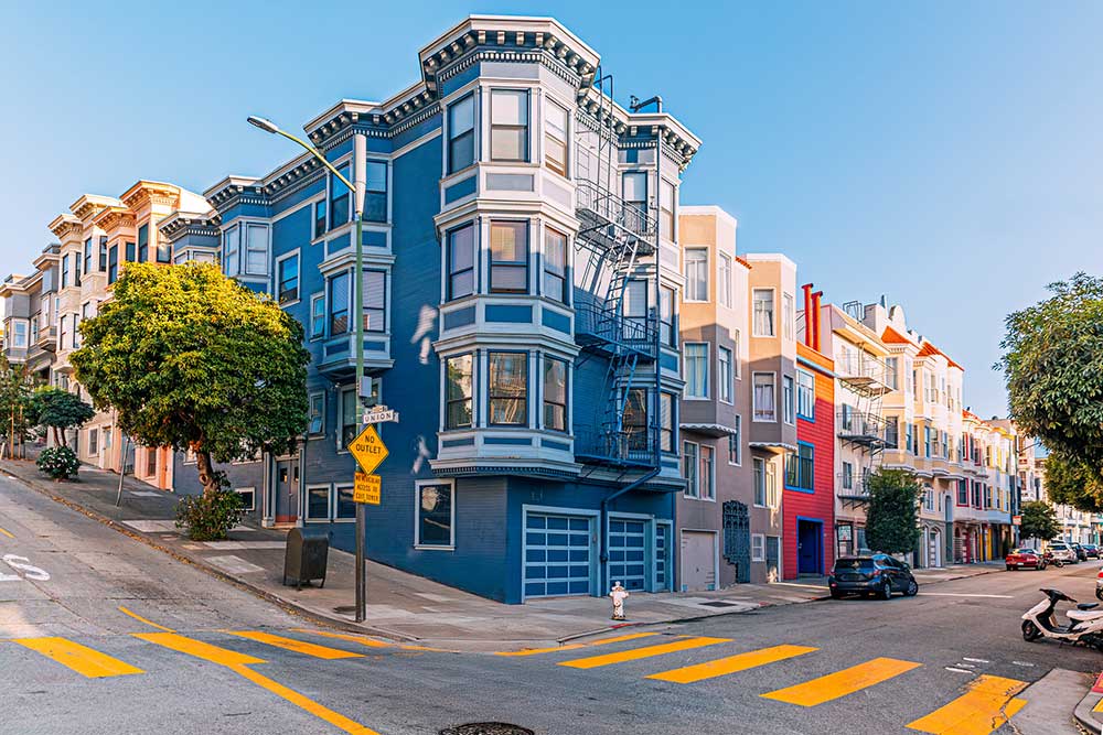 Street with colorful Victorian style apartment building in San Francisco