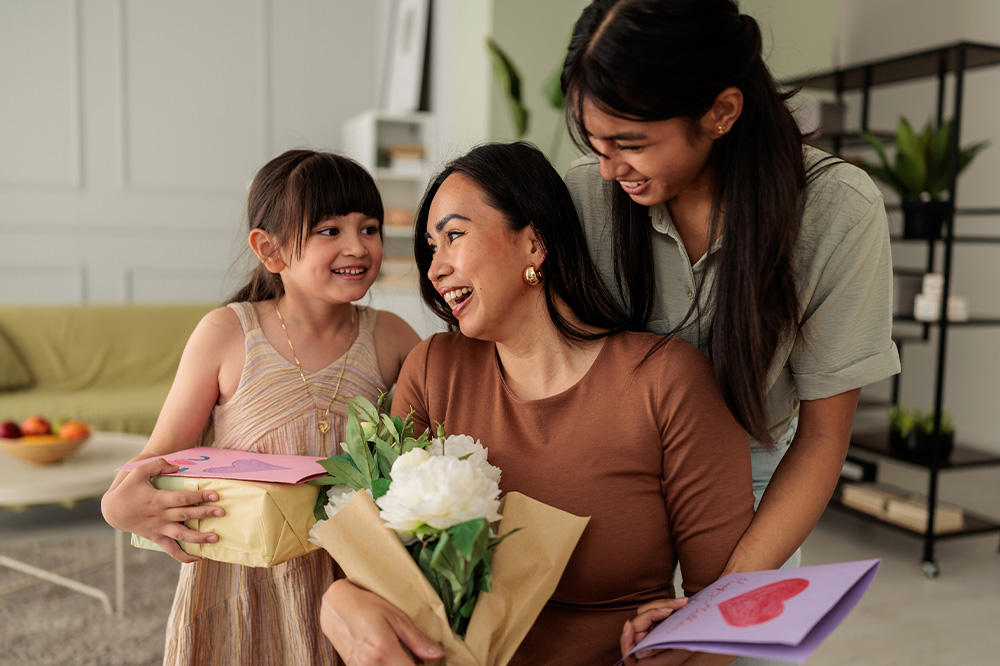 Daughters Surprising Their Mother with Gifts on Mothers Day 1000x666
