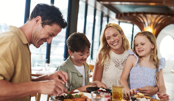 People sharing a meal at a restaurant table indoors.