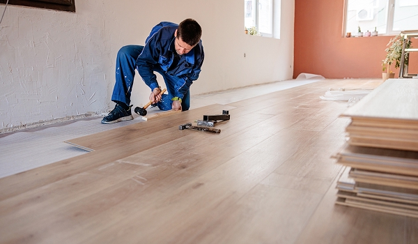 Man installing new laminate wooden style floor